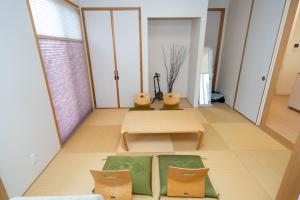 a living room with a table and two chairs at ISE Resort 綾 UZ1 in Ise