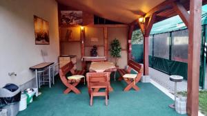 a room with a table and chairs on a porch at Villa MarViK in Lučenec