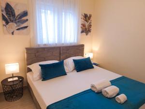 a bedroom with a large bed with blue and white pillows at Villa TeSa in Sevid +35 photos