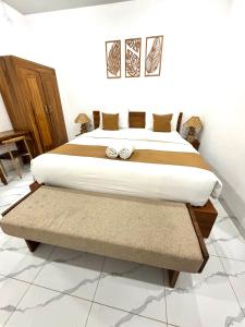 a bedroom with a large bed in a room at Lestari Homestay Jimbaran in Jimbaran
