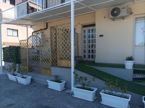 a row of potted plants sitting outside of a building at Brezza Marina in Cirella