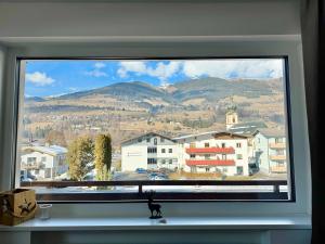 a window with a view of a city and mountains at Apartment Angela in Mittersill