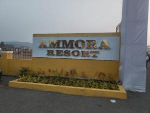a sign for an americanaresist sign on a building at Ammora Resort in Kārli