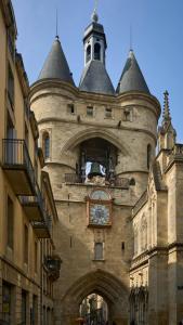 a building with a clock on the side of it at my HOTEL Bordeaux in Artigues-près-Bordeaux