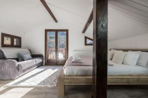 a living room with a bed and a couch at Chalet Cusco in Servoz