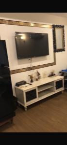 a living room with a television on a white entertainment center at Luxury Aparment in Islamabad
