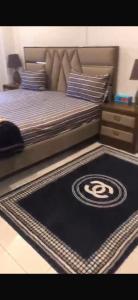 a bed with a black carpet with a miami mets rug at Luxury Aparment in Islamabad