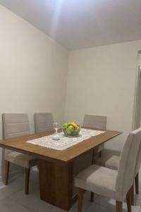a dining room table with a bowl of fruit on it at Aconchego na praia in Ilhéus