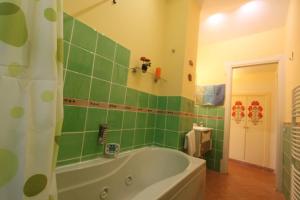 a green tiled bathroom with a bath tub in it at Princely Houses in Positano +38 photos