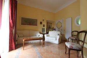 a living room with a couch and a chair at Princely Houses in Positano