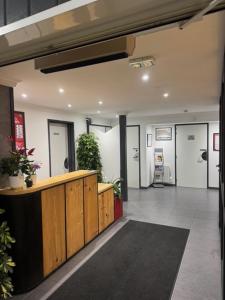 a lobby with a reception desk in a building at my HOTEL Bordeaux in Artigues-près-Bordeaux