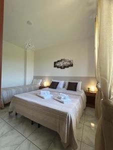 a bedroom with a bed with two towels on it at villa Giò in Racalmuto