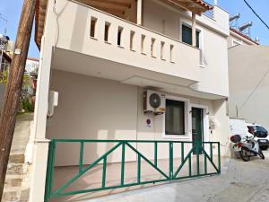 a house with a balcony in front of it at studio apartment KAMARES in Mytilene