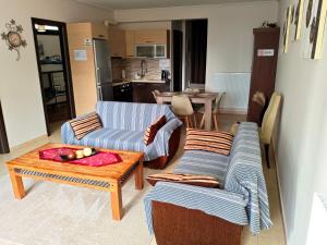 a living room with two couches and a table at studio apartment KAMARES in Mytilene