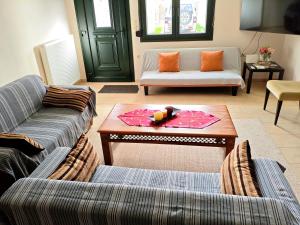 a living room with two couches and a coffee table at studio apartment KAMARES in Mytilene