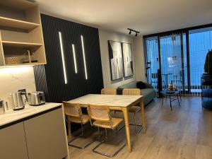a kitchen and living room with a table and chairs at Las Condes Avenida in Santiago +35 photos