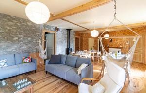 a living room with a blue couch and a table at Aubépine in Cadéac