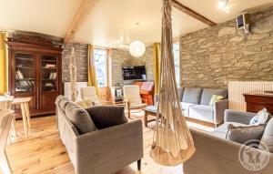 a living room with a hammock in a house at Aubépine in Cadéac