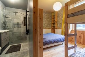 a bedroom with a bunk bed and a shower at Aubépine in Cadéac