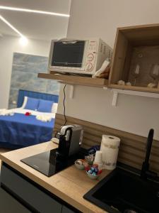 a kitchen with a counter with a toaster and a microwave at Domus Anna in Bacoli +26 photos