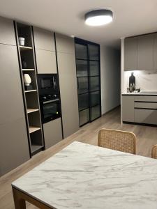 a kitchen and dining room with a table and chairs at Las Condes Avenida in Santiago