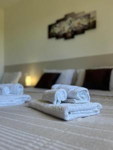 three towels sitting on top of a bed at villa Giò in Racalmuto +12 photos