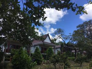 a white house with trees in front of it at Lanta Happy Hill in Ko Lanta