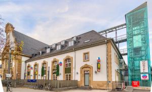 a large white building with a black roof at Hostel-Marburg-one Dorms in Marburg an der Lahn