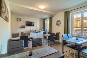 a dining room with tables and chairs and a kitchen at Hostel-Marburg-one Dorms in Marburg an der Lahn
