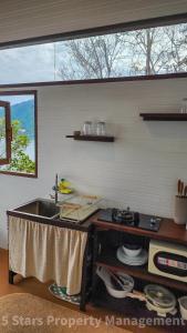 a kitchen counter with a sink and a window at Epic Views Cabins - Ocean or Mountains, your choice in Ko Phangan