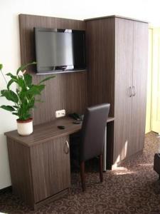 a desk with a chair and a computer in a room at Pension Luft in Dresden