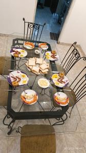 a table with plates of food on it at White Umbrella - Homestay in Beruwala +38 photos