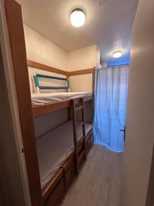 a small room with two bunk beds in it at Studio cosy 4 pers, à APOLLO - Pied des pistes - SkiOpied, Casier à skis - Parking Gratuit - Domaine des Sybelles in Villarembert +34 photos