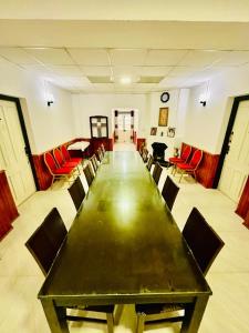 a conference room with a long table and red chairs at Silver Meir Villa in Nuwara Eliya