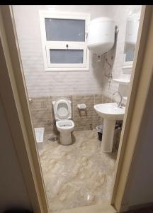 a bathroom with a toilet and a sink at Madinaty B12 Guesthouse Shared Apartment - Garden View in Madinaty +52 photos