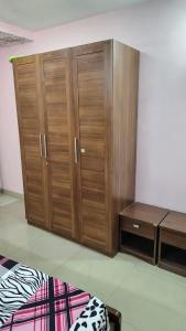 a pair of wooden cabinets in a room at Gem Backpackers hostel in Siliguri