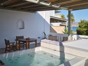 a pool in a house with a view of the ocean at Marinatou Suites in Antiparos
