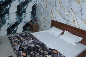 a bedroom with a bed with a wall mural at Hotel Indian Lemon Tree in Jīnd