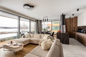 a living room with a couch and a table at Zegrze Riva with the view in Zegrze Południowe