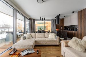 a living room with a couch and a table at Zegrze Riva with the view in Zegrze Południowe