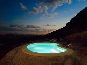 a large swimming pool in the middle of a mountain at Casa Romeriko piscina privada vistas espectaculares Valle de Ricote Murcia in Ricote