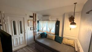 a living room with a couch and a window at Apartment Sabljaci by the Lake in Ogulin