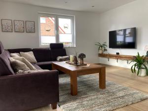 a living room with a couch and a coffee table at Andi's Auszeit in Dörpen