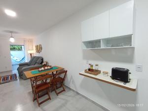a living room with a table and a couch at Casa Lego Paraty in Paraty