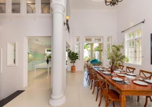 a dining room with a long table and chairs at AnNam Village 4 in Vung Tau