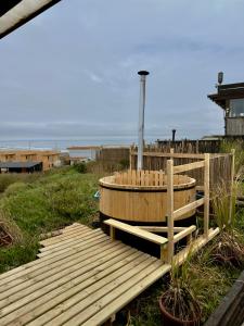 a wooden deck with a hot tub on the beach at Casa al mare due - Matanzas y Pupuya in Navidad