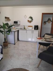 a living room with white cabinets and a table at Apartment CALISTROS BENITACHELL MINIMUM STAY ONE NIGHT in Benitachell