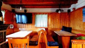 a room with a table and a tv in a room at Chalet Zala at Vogel mountain - cable car access or hiking - not reachable with car in Ukanc