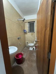 a bathroom with a toilet and a sink at Harmony Palace in Nashik