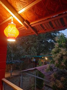 a light hanging from awning on a patio at Lalitha Farm Stay in Tumkūr